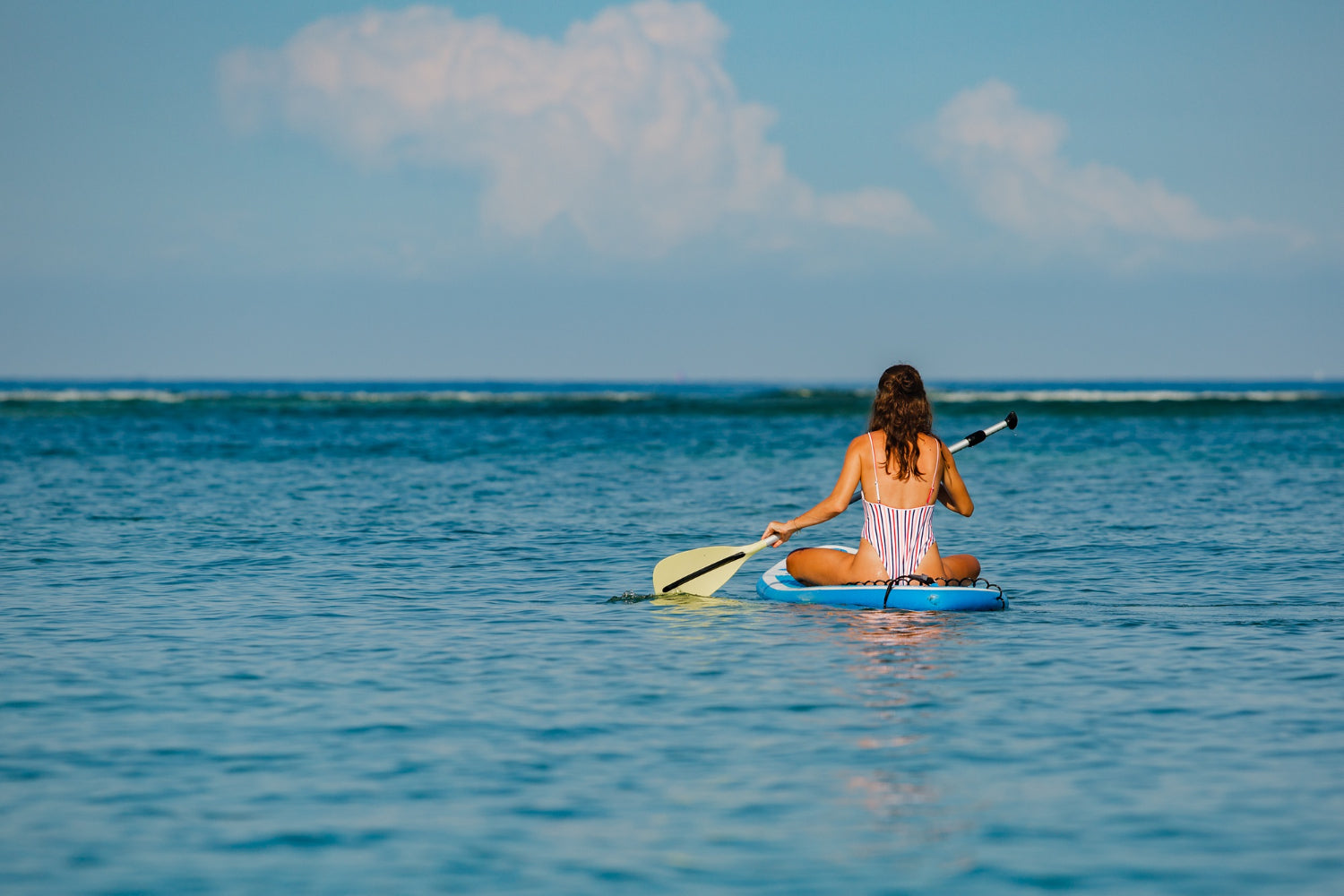 a woman ocean kayaking