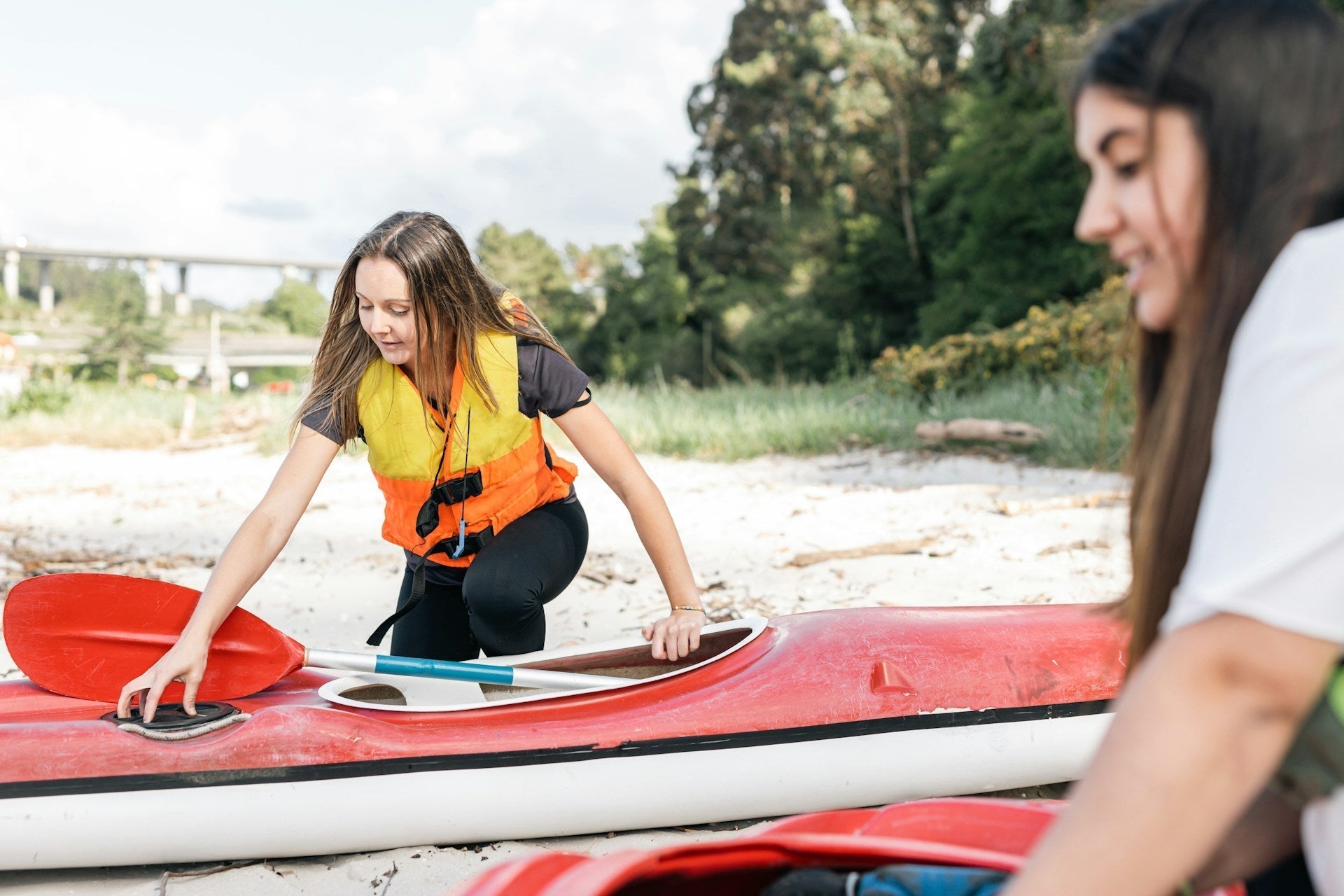 two women getting ready for ocean kayaking