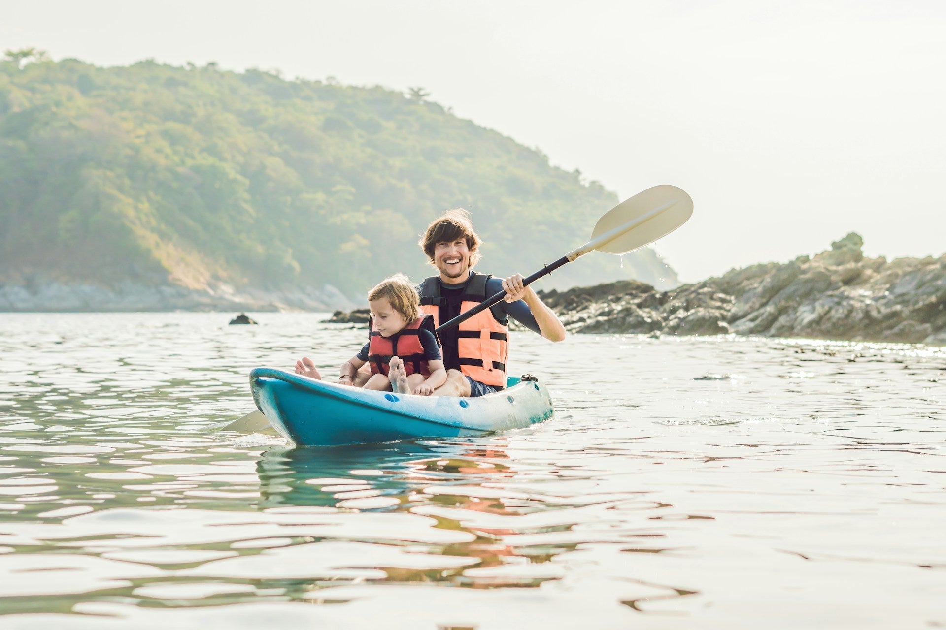 father-and-son-kayaking-at-tropical-ocean